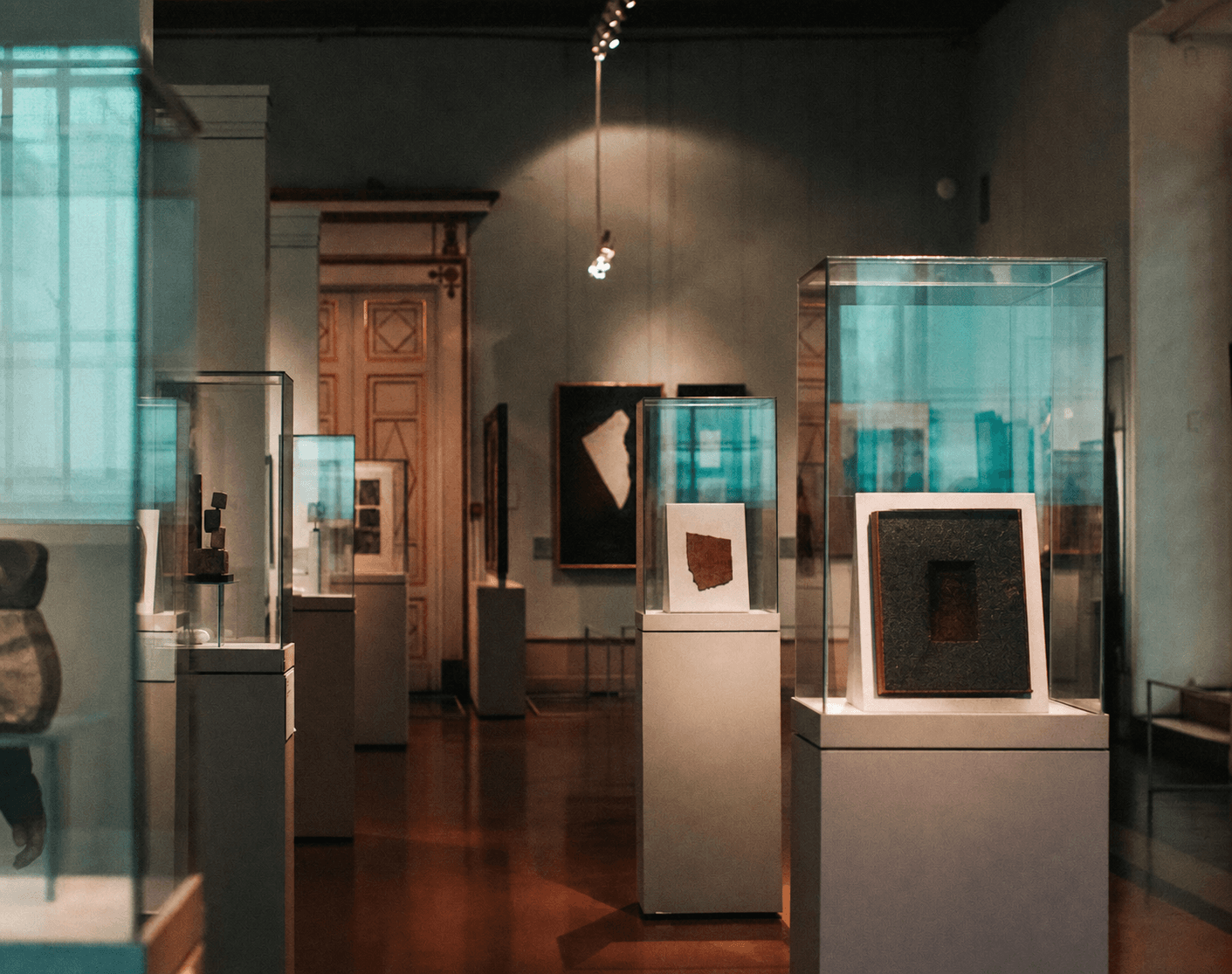 Gallery interior with contemporary abstract works inside the original display cases