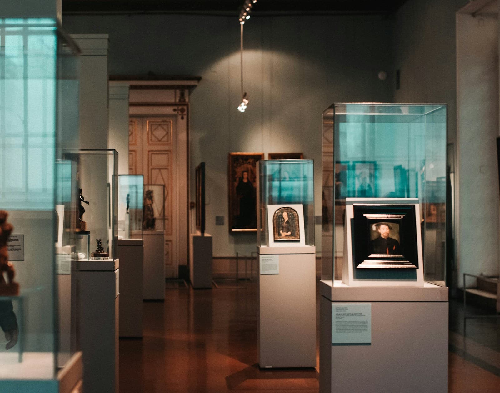 Gallery interior with artworks displayed in glass cases